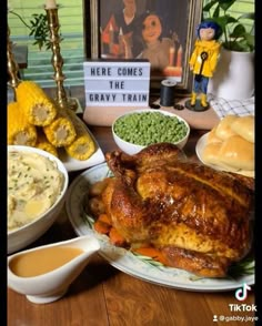 there is a large turkey on the table with other foods and condiments around it