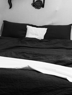 a black and white photo of a bed