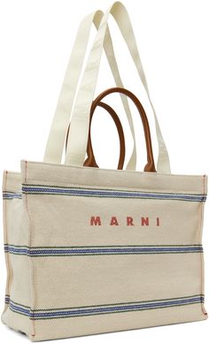 Hopsack tote in off-white. · Buffed calfskin trim and stripes throughout · Twin rolled carry handles · Twin logo-woven webbing shoulder straps · Jacquard logo at face · Zip pocket at interior · Unlined · H13 x W16 x D8 · Total height: H21.5 Supplier color: Natural/Moka Designer White Bag With Embroidered Logo, Modern Rectangular Bag With Embroidered Logo, Cream Tote Shoulder Bag With Logo, Cream Logo Tote Shoulder Bag, Modern Bag With Embroidered Logo For Daily Use, White Bags With Embroidered Logo And Double Handle, Designer White Bag With Canvas Lining, White Designer Bag With Canvas Lining, Designer White Bags With Canvas Lining