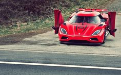 a red sports car is parked on the side of the road