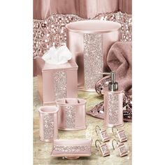 a pink bathroom set with soap dispenser, toothbrush holder and other items