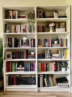 a bookshelf filled with lots of different types of books on top of it