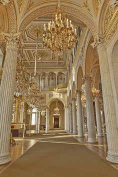 an ornate building with columns and chandeliers