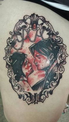 a woman's back with a tattoo on it that has two people in the frame