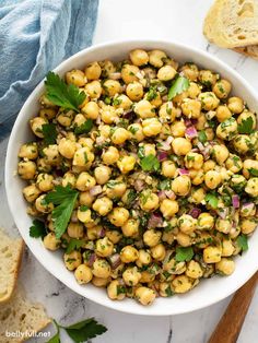 a white bowl filled with chickpeas and garnished with cilantro