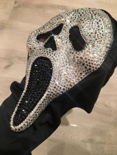 a black and white mask with sequins on it