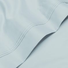 close up view of white sheets and pillow cases