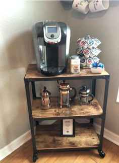 a coffee maker on top of a wooden shelf