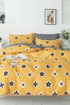 a yellow bed with black and white flowers on it