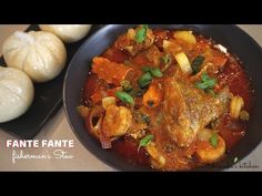 a pan filled with meat and vegetables next to garlic