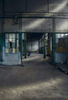 an empty building with lots of windows and doors