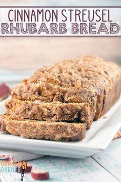 a loaf of bread on a white plate with cranberry toppings around it