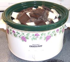 a crock - pot filled with chocolate and marshmallows on the counter