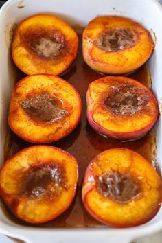 baked peaches in a baking dish ready to be eaten