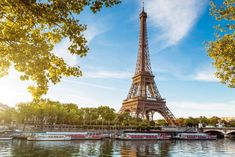 the eiffel tower is surrounded by trees and boats