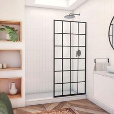 a bathroom with a shower, sink and mirror