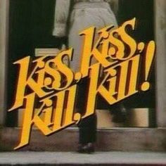 a man standing in front of a door with the words kiss kill on it