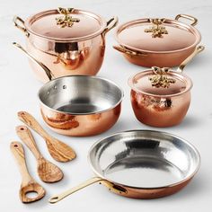 copper pots and pans with wooden utensils