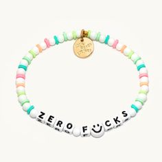 a bracelet with the word zero f's written in white, green, and pink beads