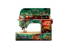 an old sewing machine with flowers painted on it