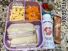 lunch box with sandwich, chips and fruit