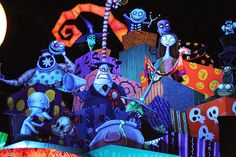 an elaborately decorated display at night with lots of cartoon characters on the front and sides