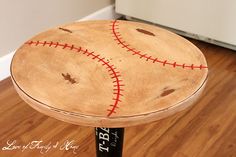 a wooden stool with a baseball painted on it