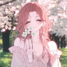 a girl with long hair holding flowers in her hand and looking at the camera while standing next to some trees