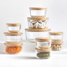 there are many glass containers with nuts in them