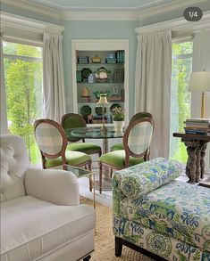 a living room filled with furniture and a fire place in front of a glass table