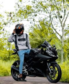 a person sitting on top of a black motorcycle