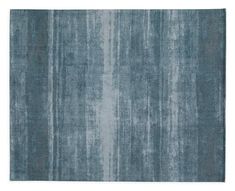 a blue rug with vertical stripes on the bottom, and an over - dyed background