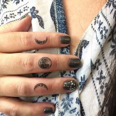 a woman's hand with some black and white designs on it