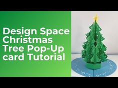 a paper christmas tree sitting on top of a blue stand with the words design space christmas tree pop - up card