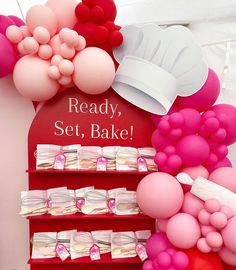 there is a display with balloons, cake and other items on the shelves for sale