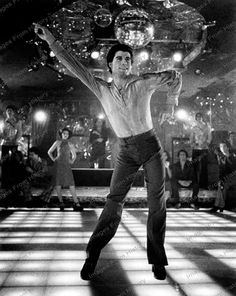 elvis presley dancing on the dance floor in front of an audience at a nightclub, with his arms stretched out