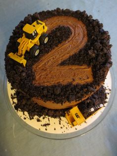 a cake with chocolate frosting and construction vehicles on it