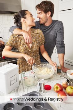 a man and woman in the kitchen preparing food