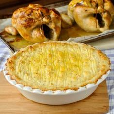 a pie sitting on top of a wooden cutting board