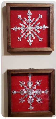 two framed snowflakes are on display in wooden frames, one is red and the other is white