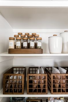 the shelves are filled with jars and containers for spices to be used in cooking or baking