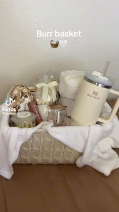 a basket filled with items sitting on top of a bed