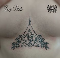 a woman's chest with a tattoo design on it