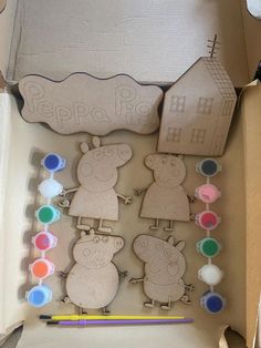 a cardboard box filled with wooden cut outs