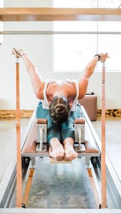 a woman is doing exercises on a machine