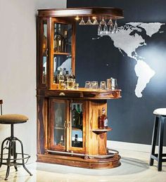 a bar with two stools and a world map on the wall in front of it