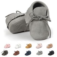 several pairs of baby shoes with different colors and sizes on the bottom, one has a bow