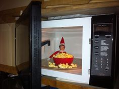 an elf is in the microwave with corn