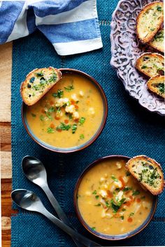 three bowls filled with soup on top of a blue cloth