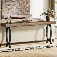 a living room with a stone wall and wooden table in front of the couches